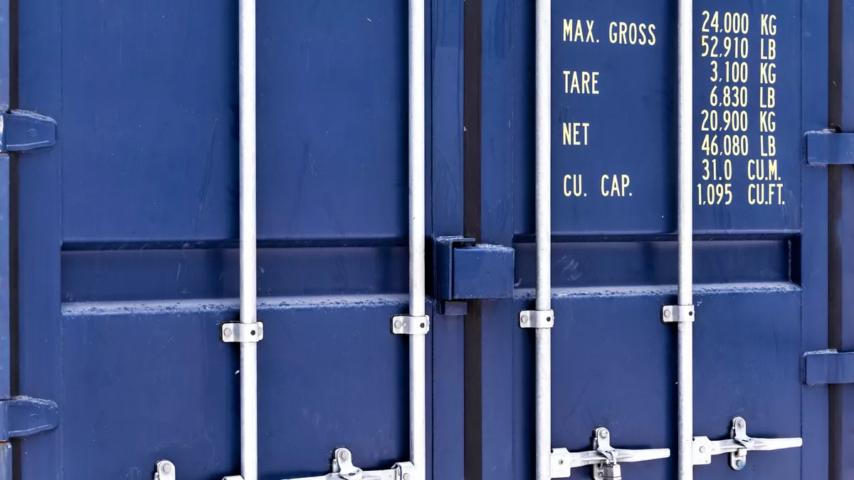 Blue shipping container doors with weight and capacity specifications in yellow text.