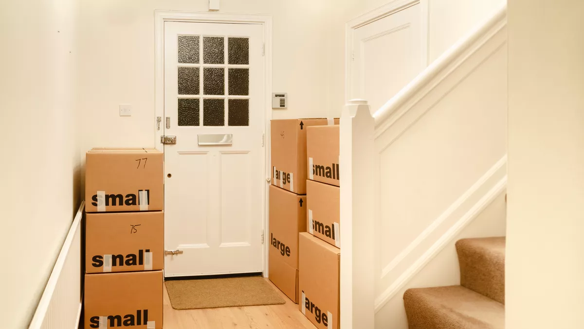 Hallway with stacked boxes labeled "small" and "large" near the entrance door.