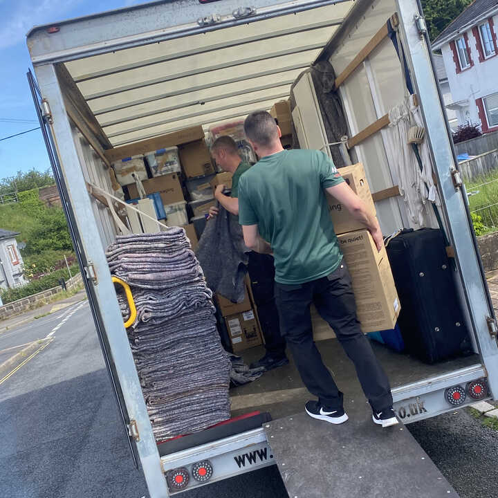 A East Devon Removals van parked on a residential street.