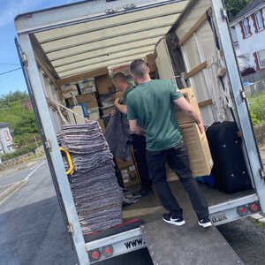 A East Devon Removals van parked on a residential street.