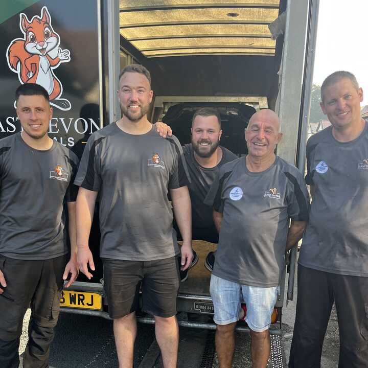 A East Devon Removals van parked on a residential street.
