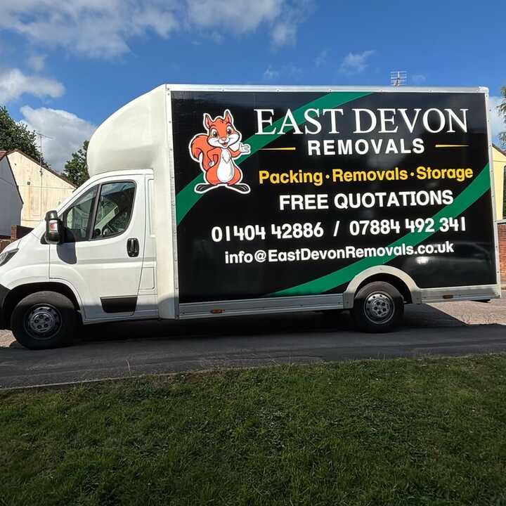 A East Devon Removals van parked on a residential street.