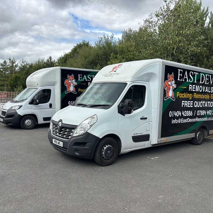 A East Devon Removals van parked on a residential street.
