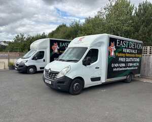 A removal truck with "East Devon Removals" branding parked on a residential street.