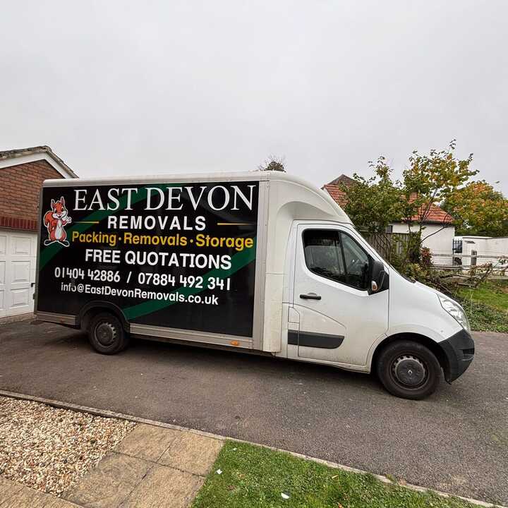 A East Devon Removals van parked on a residential street.