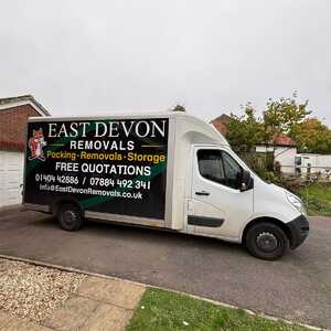 A East Devon Removals van parked on a residential street.