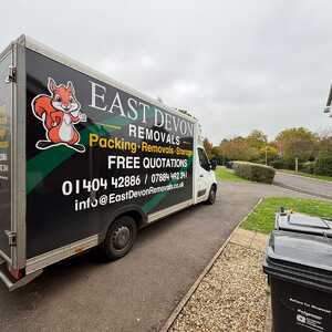 A East Devon Removals van parked on a residential street.